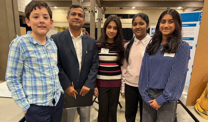 Photo of Dr. Dangi with award-winning students